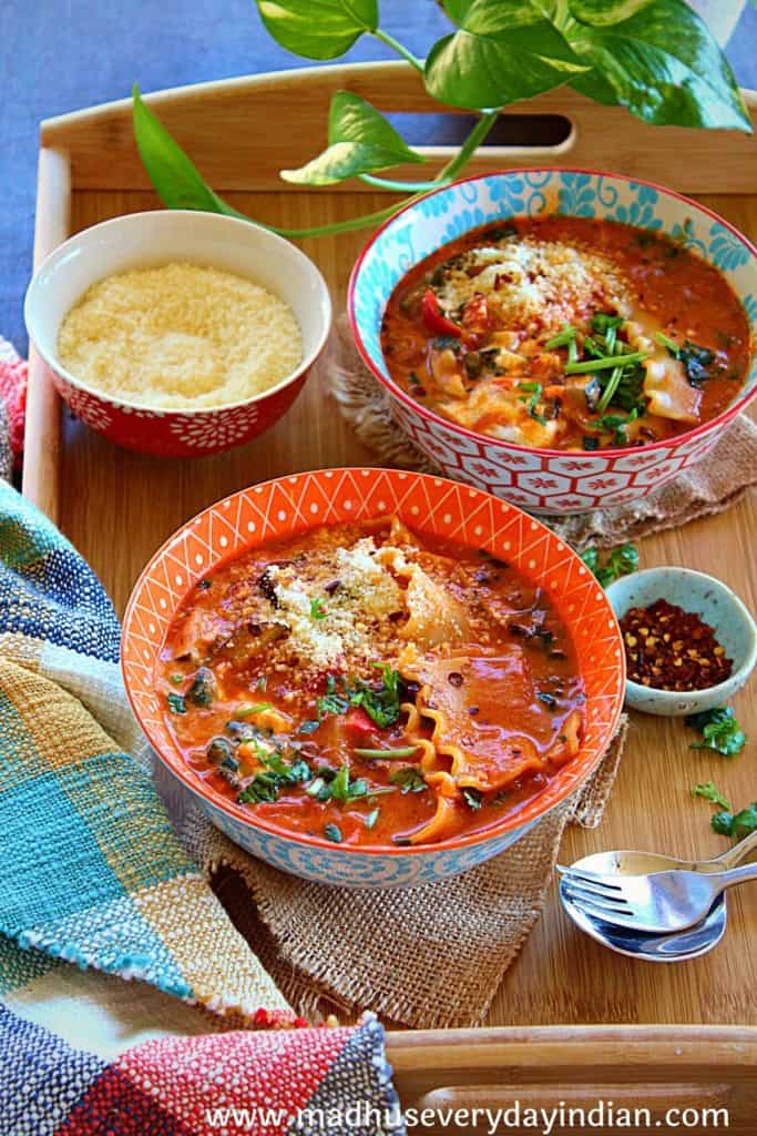 vegetarian lasagna soup served in two bowls garnished with parsley and parmesan cheese