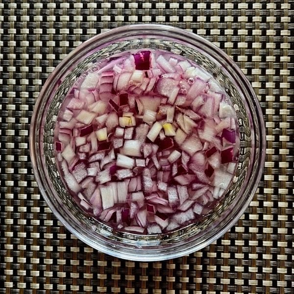 chopped onion added in  abowl with lemon juice and water