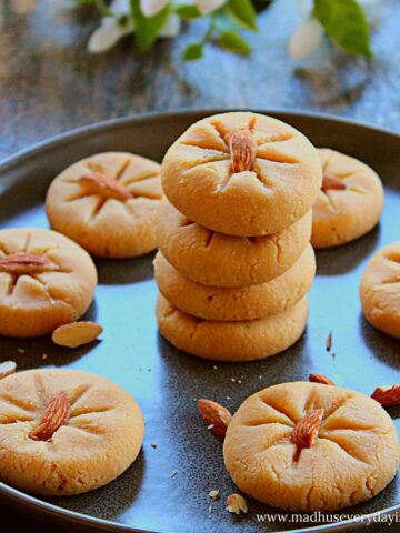 badam peda stacked on top of each other in a dark grey plate