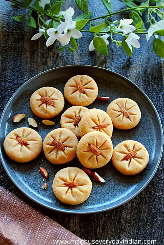 almond flour peda arranged in a plate garnished with almonds