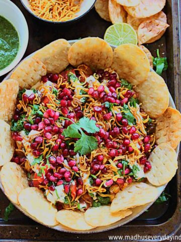 chaat dip served with papdi , sev and chutneys