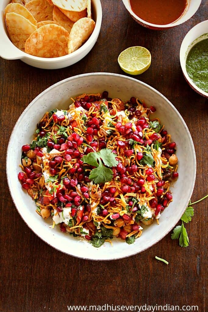 papdi chaat dip served in a large bowl with chutneys