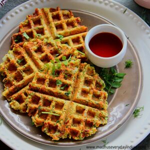 masala vada waffles served in a plate with maggi sauce