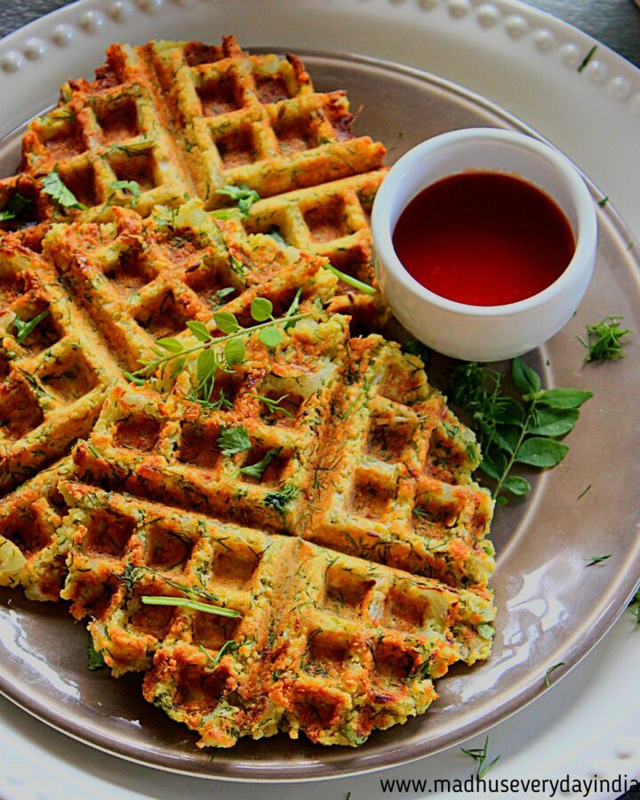 masala vada waffles served in a plate with maggi sauce