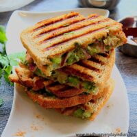 grilled bombay sandwich stacked in a white plate