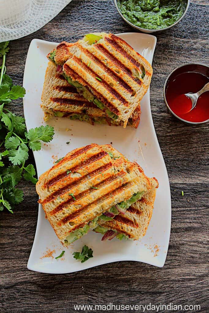 grilled bombay sandwich stacked in a white plate