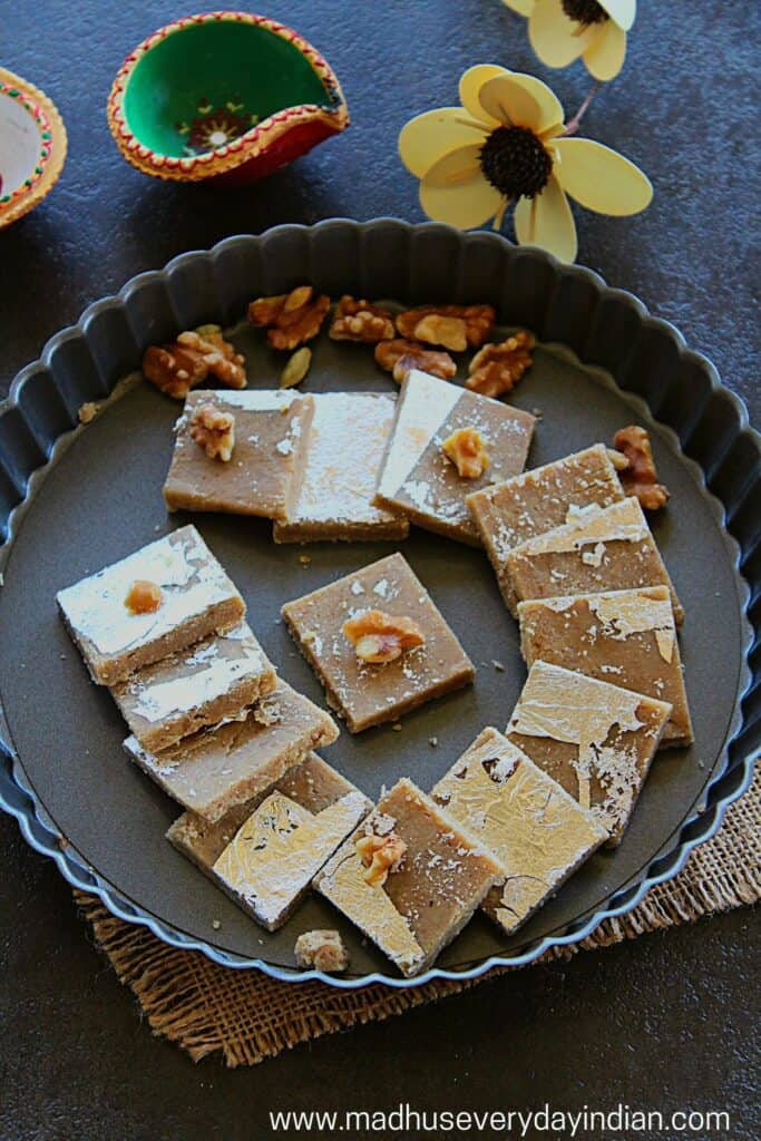 pieces of walnut burfi served in a gray plate
