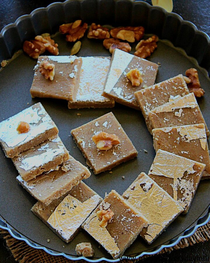pieces of walnut burfi served in a gray plate