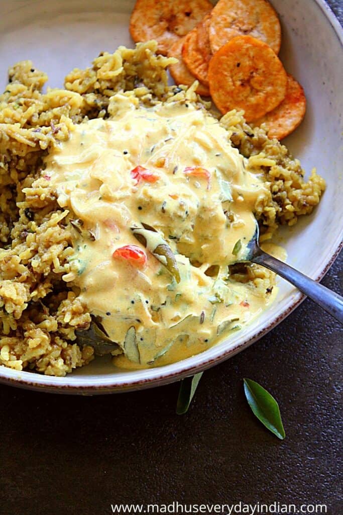 green moong dal khichdi topped with spiced yogurt