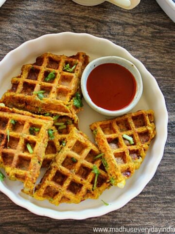 waffles served in a plate with chili sauce and coffee