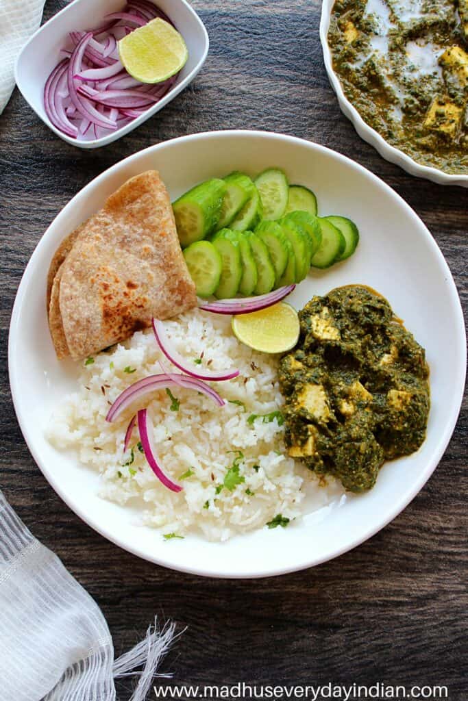 palak paneer served with roti, rice, cucumber and onion