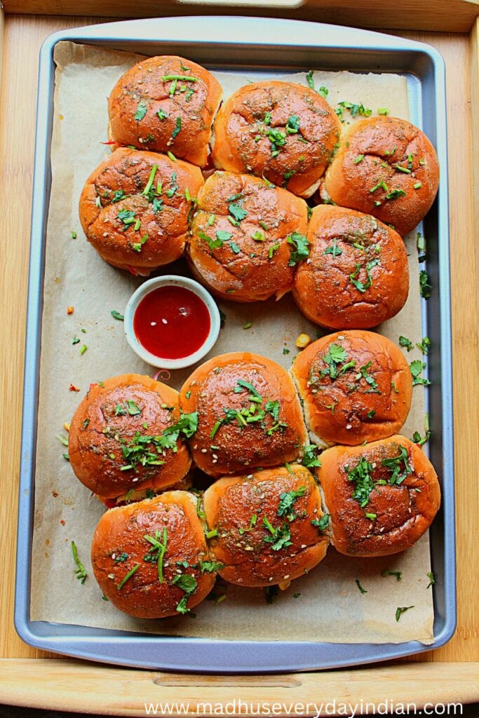 potato sliders served on a baking tary garmished with cilantro and chili sauce