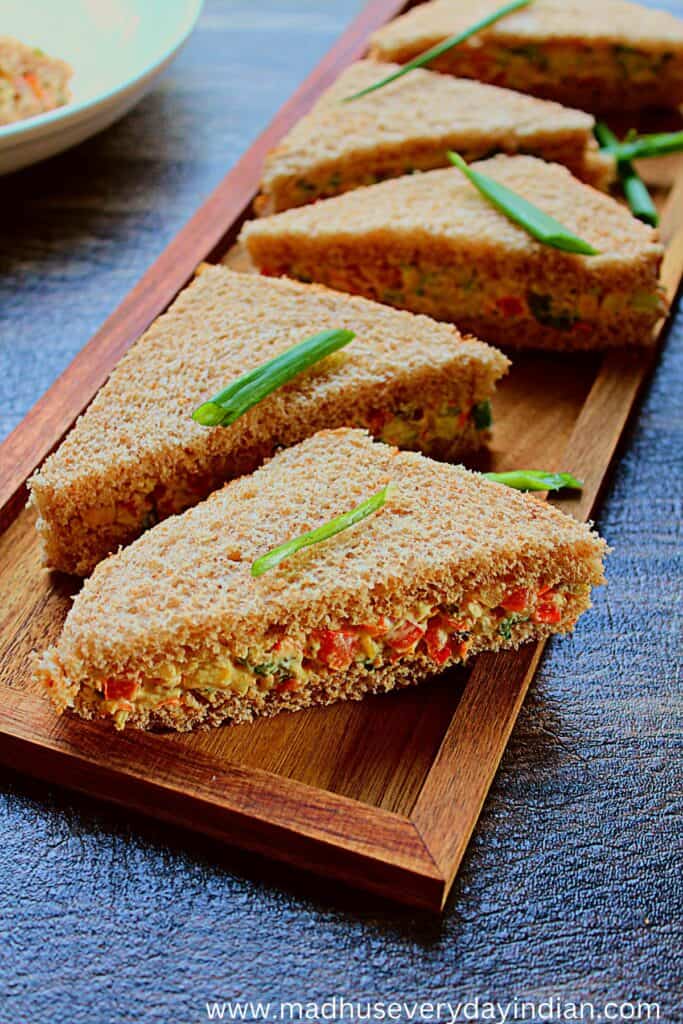 5 cream cheese veggie sandwiches served in a wooden plate