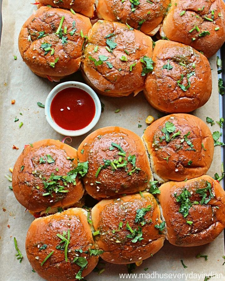 potato sliders served on a baking tary garmished with cilantro and chili sauce