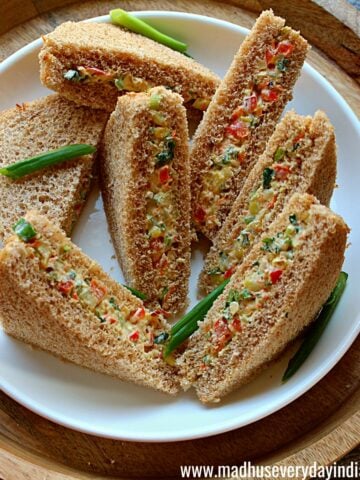veggie cream cheese cold sandwiches served in a white plate