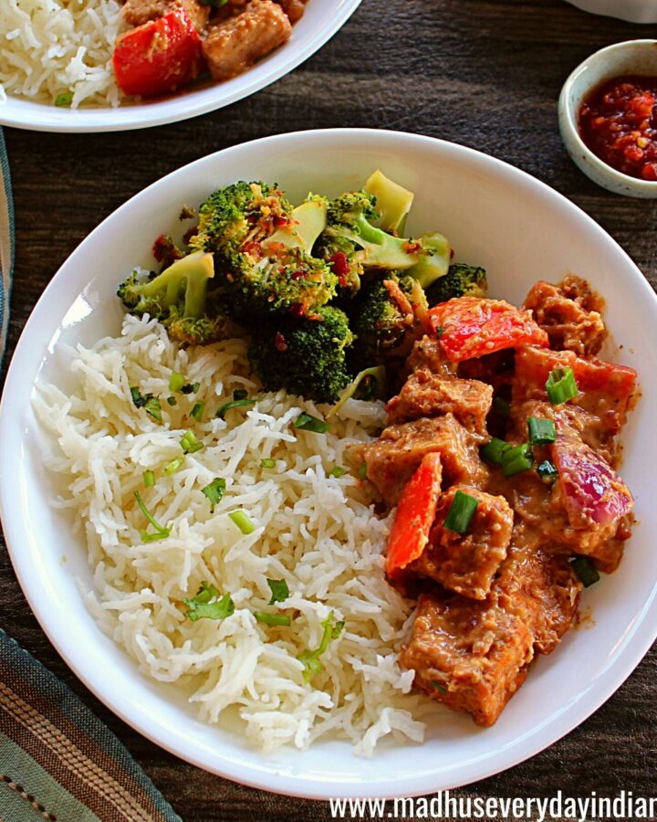rice, tofu stir fry and broccoli served in a white plate