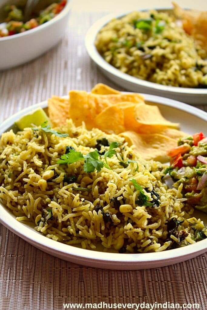 green rice close up shot served in a plate with chips