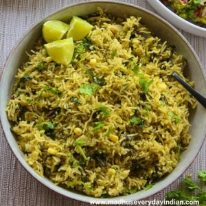 green rice recipe served in a large bowl served with lime wedges