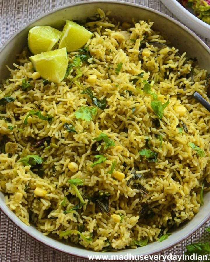 green rice recipe served in a large bowl served with lime wedges