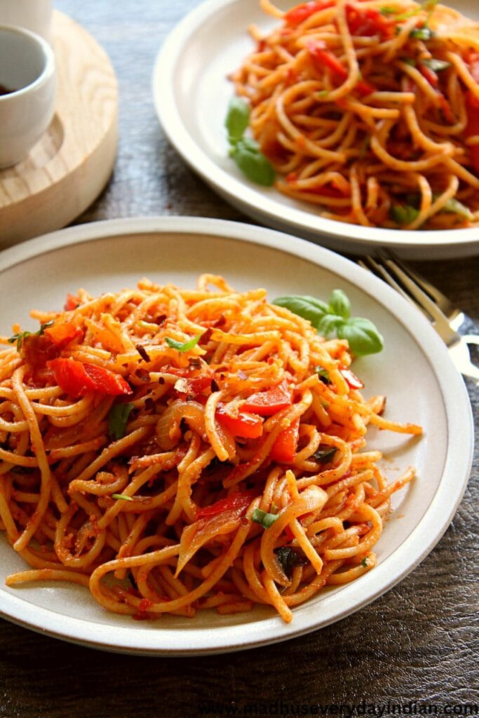 spaghetti served in a white plate