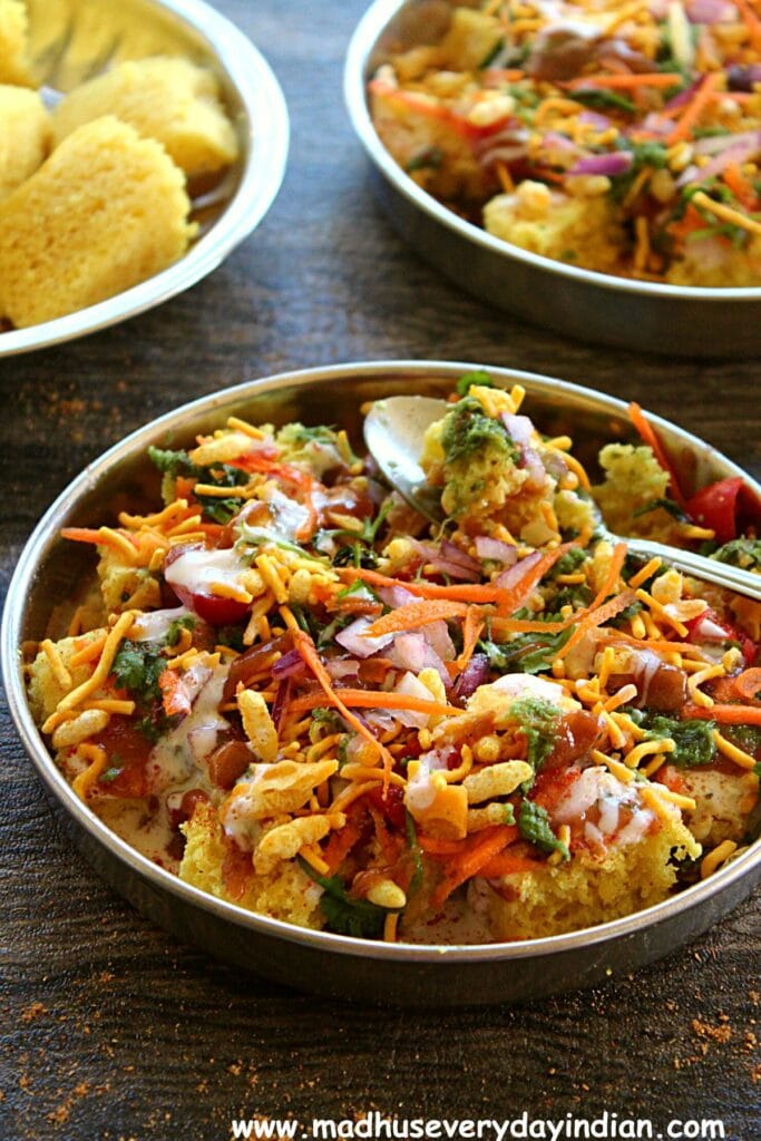dhokla chaat served in a steel plate