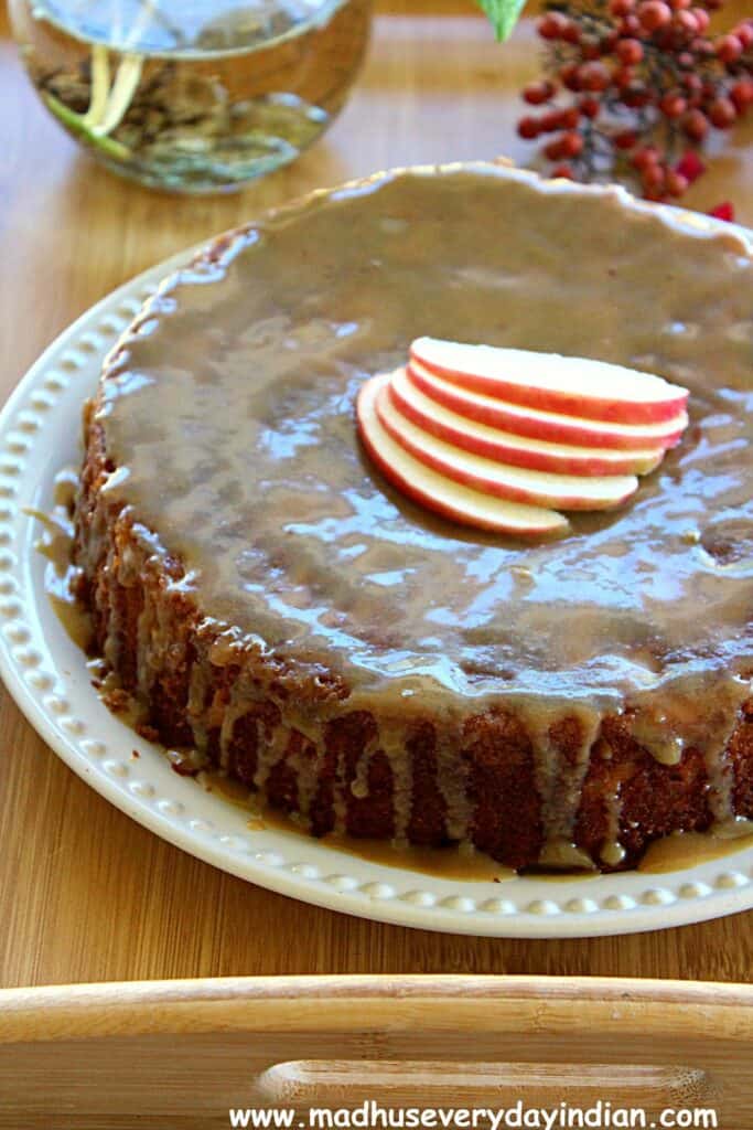 apple cake topped with brown sugar glaze and sliced apples