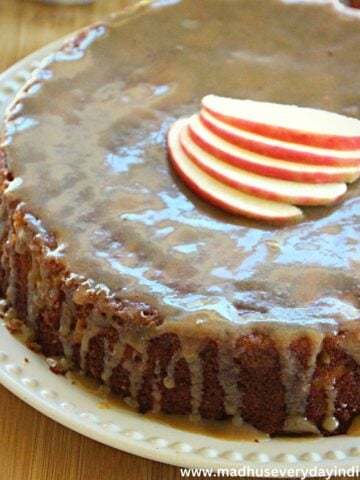 apple cake topped with brown sugar glaze and sliced apples
